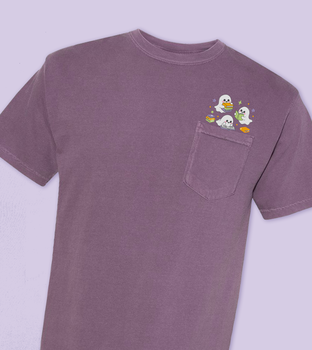 A dark purple short-sleeve pocket t-shirt featuring a small embroidered cartoon graphic of a three ghosts reading  peeking out of the chest pocket, set against a matching light purple background.